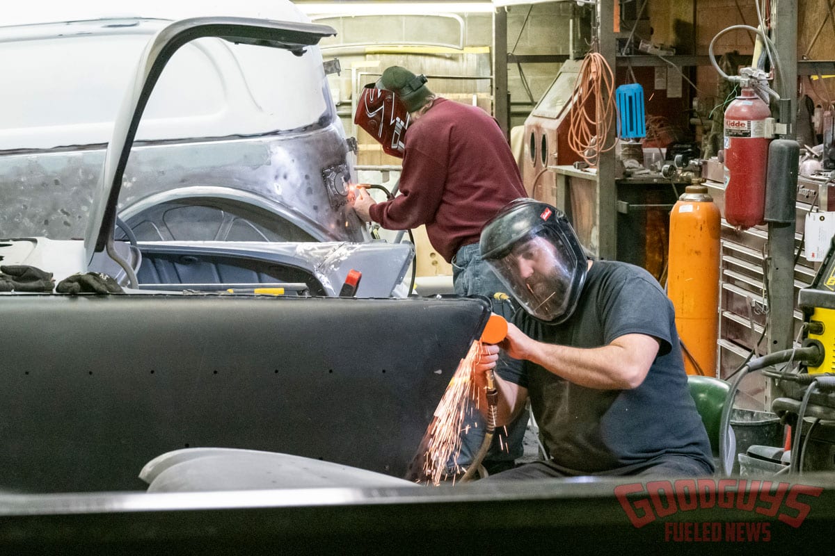 sparks fly as employees at one of rod and custom work metal on a 1957 chevy